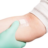 Human arm with small gauze patch