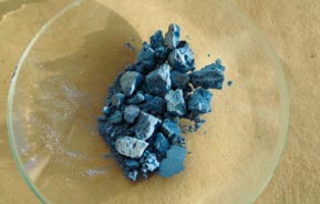 Cobalt compound sitting in glass bowl on table