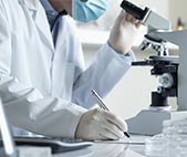 Scientist writing notes in laboratory