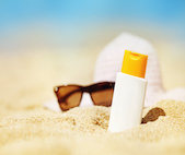 Bottle of suncreen on a beach