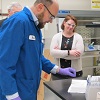 Scientists observing laboratory operations