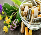 Botanical dietary supplements pills in a glass bowl