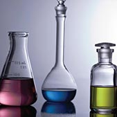 Collection of chemical glassware filled with colorful liquid