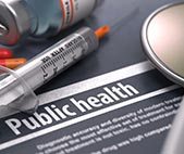 Composite image with the word 'public health,' a stethescope, empty syringe, and medicine capsules