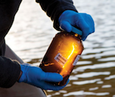 West Virginia researcher collecting water sample from the Elk river