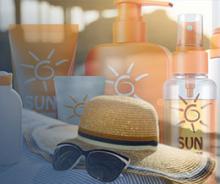 Image of sunscreen products, hat, and sunglasses