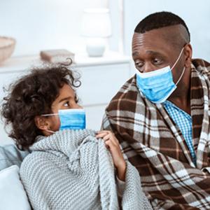 girl and a man wearing protective masks at home