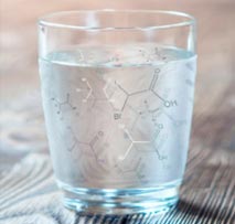 Glass of water with chemical formulas composited on top